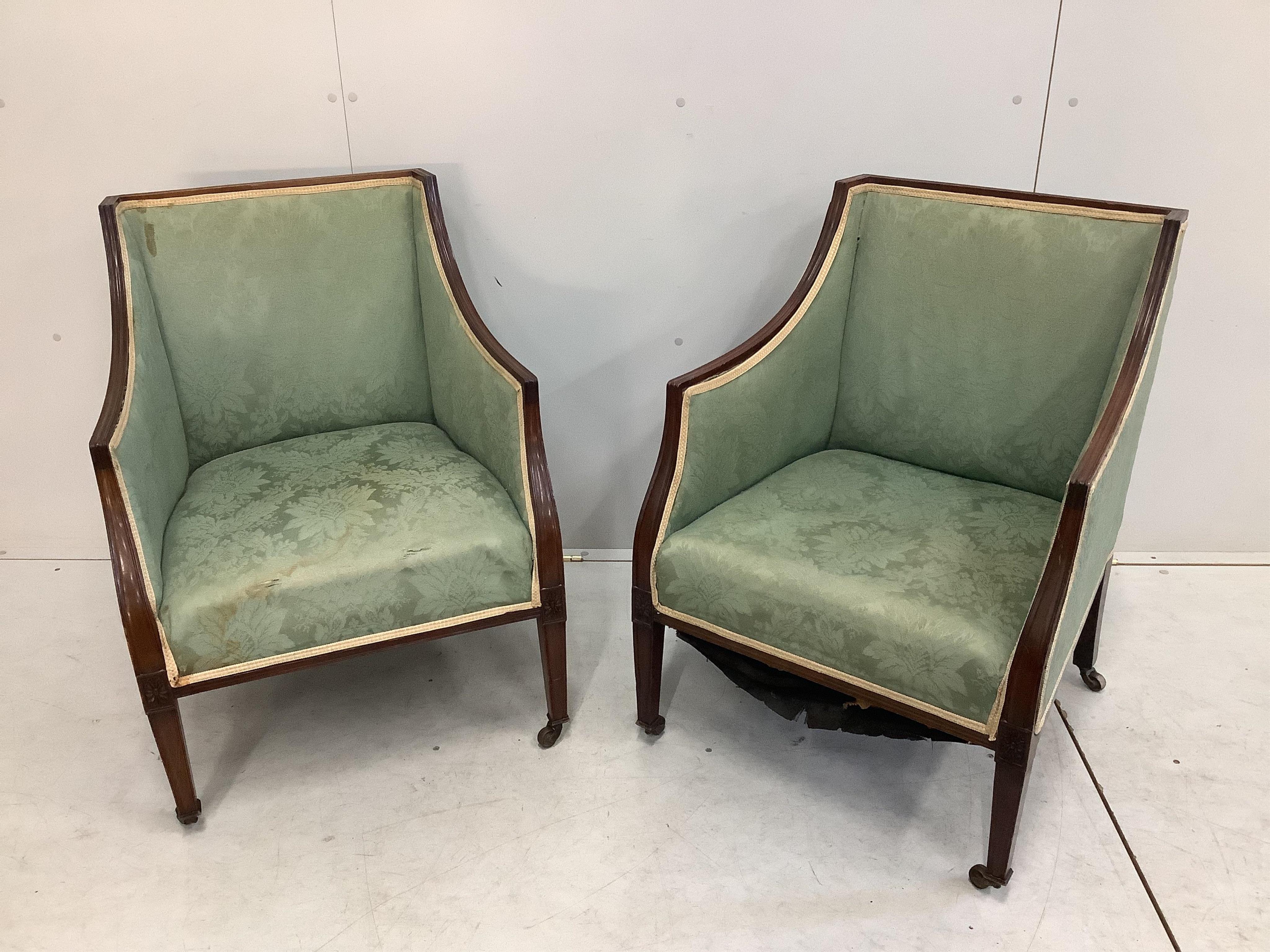 A pair of Edwardian mahogany armchairs, width 59cm, depth 55cm, height 79cm. Condition - fair, upholstery poor